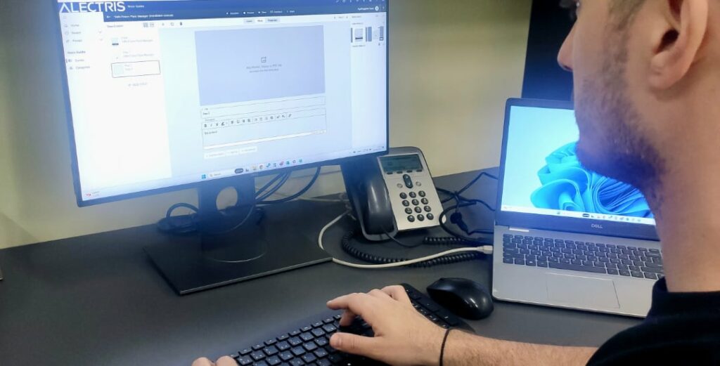 Alectris reviewing guides at a desktop computer