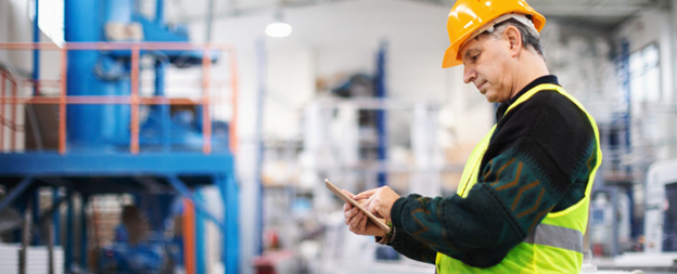 Kemp and Lauritzen worker inspecting assets with a tablet